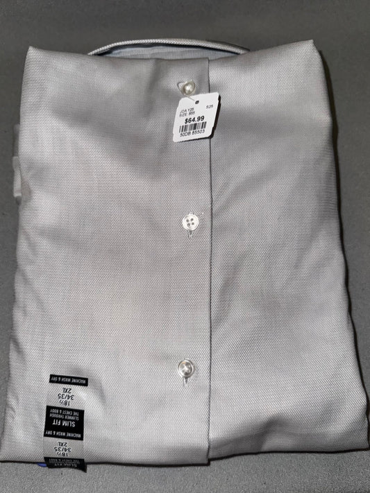 Folded gray dress shirt with tags on a gray background